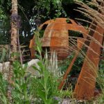 Garden deck with custom-built seating and decorative pond