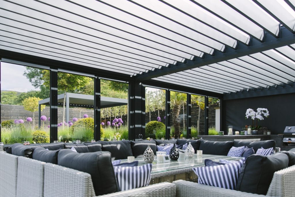 Outdoor kitchen and dining area in a luxury garden