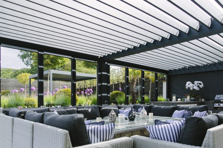 Outdoor kitchen and dining area in a luxury garden