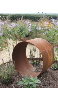 rusty pipe in garden rockery