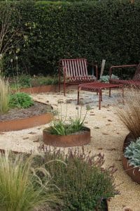 yellow gravel path and red chairs